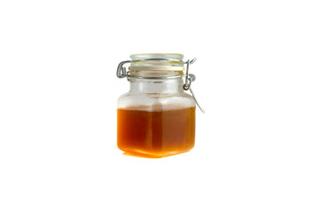 Honey in jar isolated on white background with selective focus