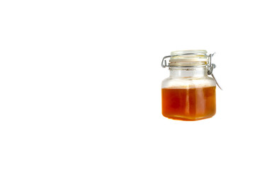 Honey in jar isolated on white background with selective focus