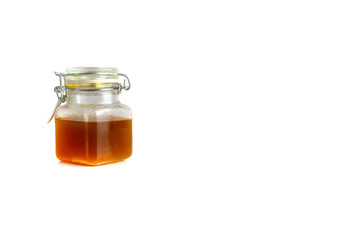 Honey in jar isolated on white background with selective focus