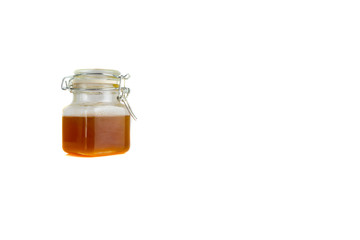 Honey in jar isolated on white background with selective focus