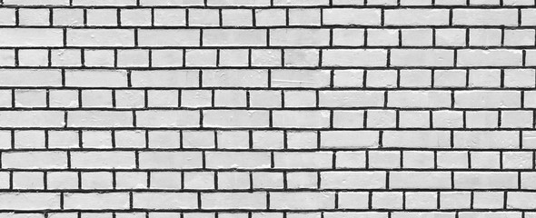Old white wash brick wall texture. Wide panorama of masonry	