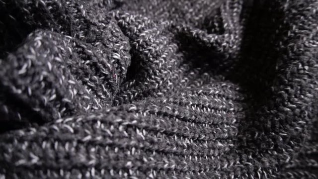 Slow rotating or spinning shot of a luxury grey dress knitwork.