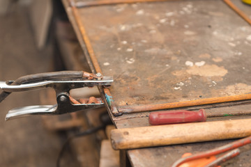 Work with welding in the carpentry shop. Weld metal parts. Dangerous industry