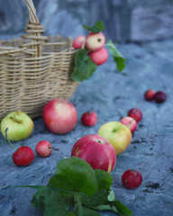 vintage basket and apples on stone background