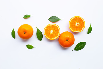Fresh orange citrus fruits with leaves on white background.