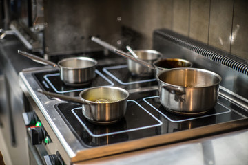 Pots on the stove in the restaurant. Cooking food.