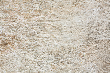 Outdoor scratched beige concrete wall