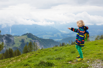 Fototapeta na wymiar Children hiking in Alps mountains. Kids outdoor.