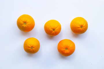 Fresh orange citrus fruit on white wooden background.
