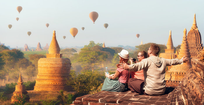 Happy tourists, friends, vacationers in the summer holidays in Asia