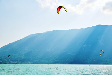 Colorful paragliding formation above Santa Croce Lake