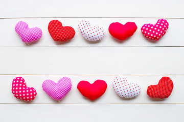 Valentine's hearts on white wooden background.