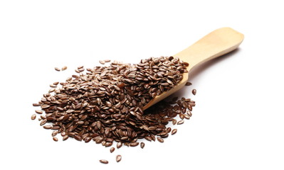 Flax seeds, linseed pile with wooden spoon isolated on white background