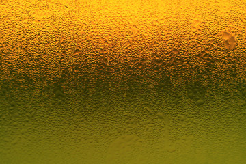 Artistic condensation on vibrant orange and green color glass bottle  - obrazy, fototapety, plakaty