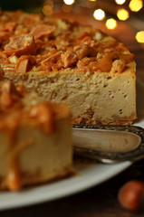 Cheesecake with nuts and caramel on a white plate