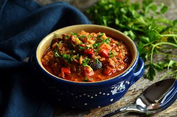 Georgian goulash soup in a blue bowl on a wooden background