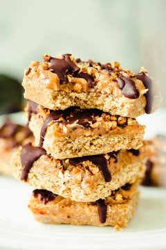 Raw vegan dessert with oats, nuts and dates on a white marble table. Healthy lifestyle and sugar free. dessert concept.