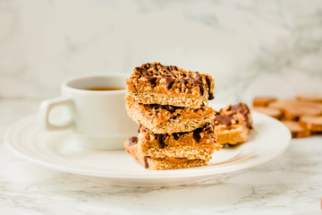 Paleo chocolate energy bars with rolled oats, nuts, dates caramel, chia seeds and coconut flakes. Horizontal.Copy space for text.