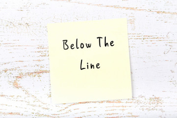 Yellow sticky note with handwritten text below the line