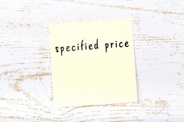 Yellow sticky note with handwritten text specified price - obrazy, fototapety, plakaty