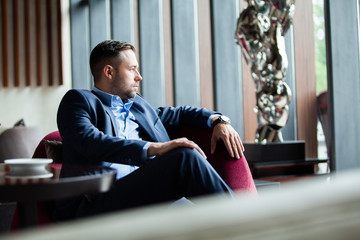 Enjoy every day of your life. Positive businessman sitting on the couch while resting in the...