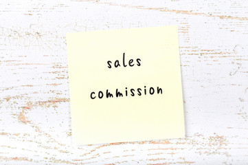 Yellow sticky note with handwritten text sales commission