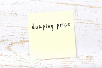 Yellow sticky note with handwritten text dumping price