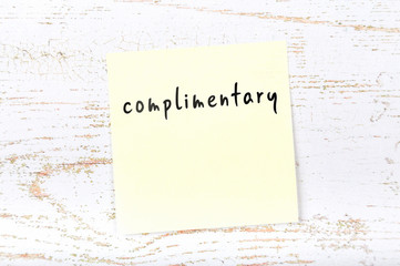 Yellow sticky note with handwritten text complimentary