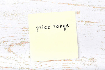 Yellow sticky note with handwritten text price range