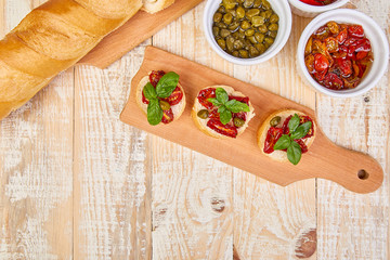 Bruschetta or crostini with sun dried tomatoes and capers