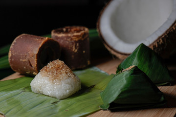 Pulut Inti. Savory glutinous rice with sweetened grated coconut wrapped in banana leaf. 