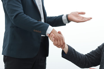 close up. businessman shaking hands with his partner