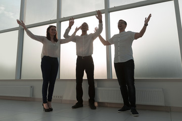 young business team standing in a bright office