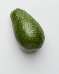 Green avocado on white background