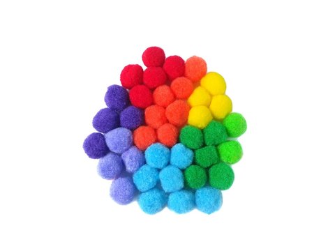 Rainbow color pom pom made from colorful fiber yarn arrange abstract shape place d on white background