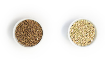 green buckwheat and ordinary buchwheat with vs sign on grey table in white bowl