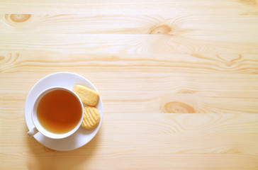 Top View of a Cup of Hot tea and Cookies on Natural Wooden Table with Free Space for Text and Design