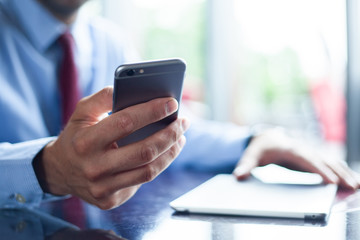 Young businessman working with modern devices, digital tablet computer and mobile phone. New technologies for success workflow concept.