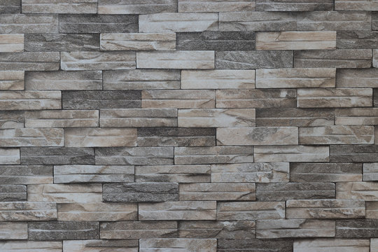 Fototapeta Gray brick wall background. Pattern of grey and rough sandstone wall texture. Gray brick wall  Modern.