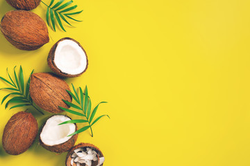 Fototapeta na wymiar Bright yellow tropical background with coconuts