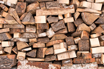 The background texture of a large pile of wood. Close up