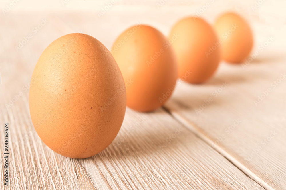 Wall mural chicken eggs on a wooden table. selective focus.