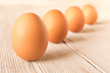 Chicken eggs on a wooden table. Selective focus.