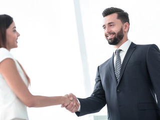 Image of business partners handshaking in office