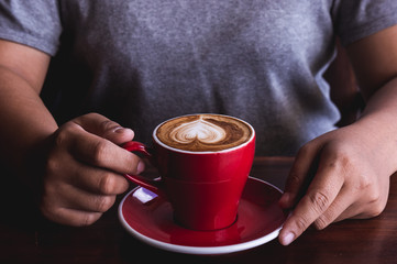 woman holding red cup coffee , drinking coffee heart