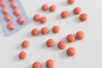 Set of orange medical pills isolated on white background. Medical care and treatment