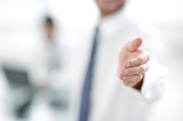 blurred image. business man holding out his hand for a handshake