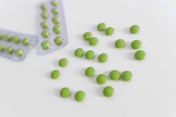 Set of green medical pills isolated on white background. Medical care and treatment