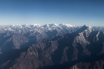 Himalayan mountain range view with snow capped peaks.