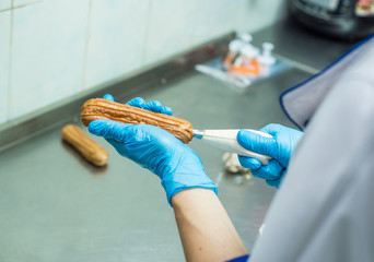 Baker fill eclair with cream